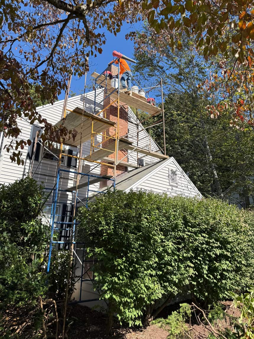 J Corrigan LLC chimney restoration team on a rooftop job site in West Hartford Connecticut